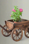 "Rustic wagon wheel planter with burnt wood finish"

"Half barrel garden planter with iron wheels"

"Country-style wooden flower pot for patios and balconies"

"Vintage decorative garden barrel planter WWP43"