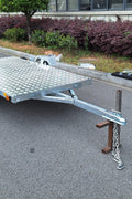 Heavy-duty galvanized 4x8 folding utility trailer with checker plate deck and road-ready tires