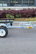 Heavy-duty galvanized 4x8 folding utility trailer with checker plate deck and road-ready tires