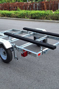 Heavy-duty galvanized 4x8 folding utility trailer with checker plate deck and road-ready tires