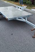 Heavy-duty galvanized 4x8 folding utility trailer with checker plate deck and road-ready tires