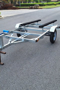 Heavy-duty galvanized 4x8 folding utility trailer with checker plate deck and road-ready tires