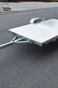 Heavy-duty galvanized 4x8 folding utility trailer with checker plate deck and road-ready tires