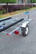 Heavy-duty galvanized 4x8 folding utility trailer with checker plate deck and road-ready tires