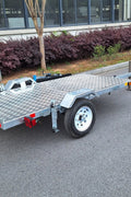 Heavy-duty galvanized 4x8 folding utility trailer with checker plate deck and road-ready tires