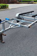 Heavy-duty galvanized 4x8 folding utility trailer with checker plate deck and road-ready tires