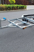 Heavy-duty galvanized 4x8 folding utility trailer with checker plate deck and road-ready tires