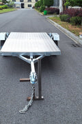 Heavy-duty galvanized 4x8 folding utility trailer with checker plate deck and road-ready tires