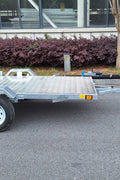 Heavy-duty galvanized 4x8 folding utility trailer with checker plate deck and road-ready tires