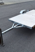 Heavy-duty galvanized 4x8 folding utility trailer with checker plate deck and road-ready tires