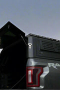 Side view of heavy-duty steel truck topper on black pickup
Modular canopy with open gullwing side door
Lockable utility cap rear view
Installation components of modular truck canopy
Steel topper installed on full-size pickup truck