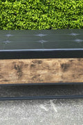 "Industrial Chesterfield-style storage bench ottoman with black metal frame, faux leather tufted top, and hidden trunk storage – Model TSLB2110"