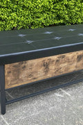 "Industrial Chesterfield-style storage bench ottoman with black metal frame, faux leather tufted top, and hidden trunk storage – Model TSLB2110"