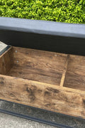 "Industrial Chesterfield-style storage bench ottoman with black metal frame, faux leather tufted top, and hidden trunk storage – Model TSLB2110"