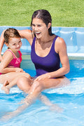 Intex Swim Center Family Lounge Pool with kids

Top view of inflatable lounge pool with bench

Inflatable family pool with built-in seat and backrest

Parents and kids relaxing in backyard pool

Blue vinyl family-size lounge pool filled with water