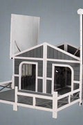Large wooden raised outdoor dog house with porch – cabin-style weatherproof pet shelter
