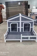 Large wooden raised outdoor dog house with porch – cabin-style weatherproof pet shelter
