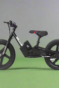 Kids 16" black electric balance bike with training wheels
Side view of 12" black lithium e-bike for children