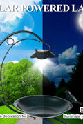 nighttime garden bird bath with solar-powered LED illumination