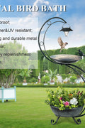 bird bathing in metal solar garden ornament with planter

metal frame bird bath with flowers and solar LED lantern

