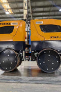 Front View of STORIKE 1114418 Remote-Controlled Trench Roller

Remote Control Device for Trench Roller Compactor

Side View of Heavy-Duty Soil Compactor Roller

STORIKE Trench Roller in Industrial Setting

Rear Angle of Remote-Controlled Soil Compactor