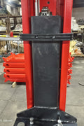 2-post vehicle lift in red installed in garage

Close-up of lifting arms and safety lock mechanism

Base of hoist with truck tires for scale

Top bar and hydraulic system – JH5000F model