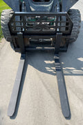 Front view of skid steer pipe grapple with clamp arms
Side view showing 48-inch clamp arm forks in use
Pipe grapple lifting construction material
Close-up of dual hydraulic clamp system