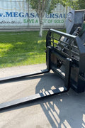 Front view of skid steer pipe grapple with clamp arms
Side view showing 48-inch clamp arm forks in use
Pipe grapple lifting construction material
Close-up of dual hydraulic clamp system