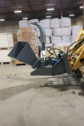 BX42 wood chipper attachment side view
Front-facing view of skid steer wood chipper BX42
Close-up of BX42 hydraulic chute and rotor
Rear view showing input hopper and feed
Mounted BX42 chipper on skid steer