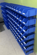 Stackable plastic bolt bins loaded with industrial tools and parts
