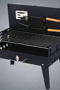 Portable suitcase-style BBQ grill folded open

Compact charcoal grill for travel and camping

Portable BBQ with meat and vegetables on the grill

Folding grill shown in backyard setup

BBQ grill packed for outdoor picnic