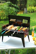 Portable suitcase-style BBQ grill folded open

Compact charcoal grill for travel and camping

Portable BBQ with meat and vegetables on the grill

Folding grill shown in backyard setup

BBQ grill packed for outdoor picnic