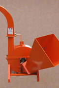 Front view of BX42T 3-point wood chipper attachment

Side profile showing 25" chipping disk on BX42T

Close-up of chipper blades and discharge chute

BX42T wood chipper connected to tractor PTO