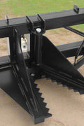 Tree and fence post puller attached to a skid steer
Side view of post puller showing steel jaws and hydraulic cylinder
Top-down view of post puller with open clamp
Puller in action removing small tree from ground
Compact and rugged post puller for skid steer