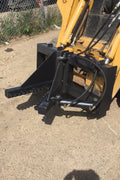 Tree and fence post puller attached to a skid steer
Side view of post puller showing steel jaws and hydraulic cylinder
Top-down view of post puller with open clamp
Puller in action removing small tree from ground
Compact and rugged post puller for skid steer
