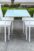 White glass dining table set with 4 chairs in the bright kitchen
Close-up of white glass table and upholstered chair
Side angle of a full 5-piece dining set
White dining chairs around a modern glass table
Dining set outdoors showing full product design